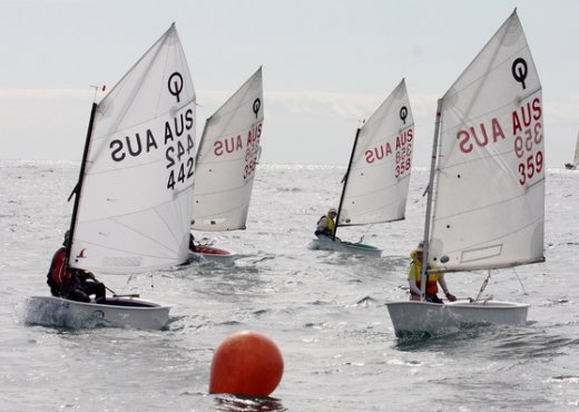 Optimist dinghy int sailboat under sail